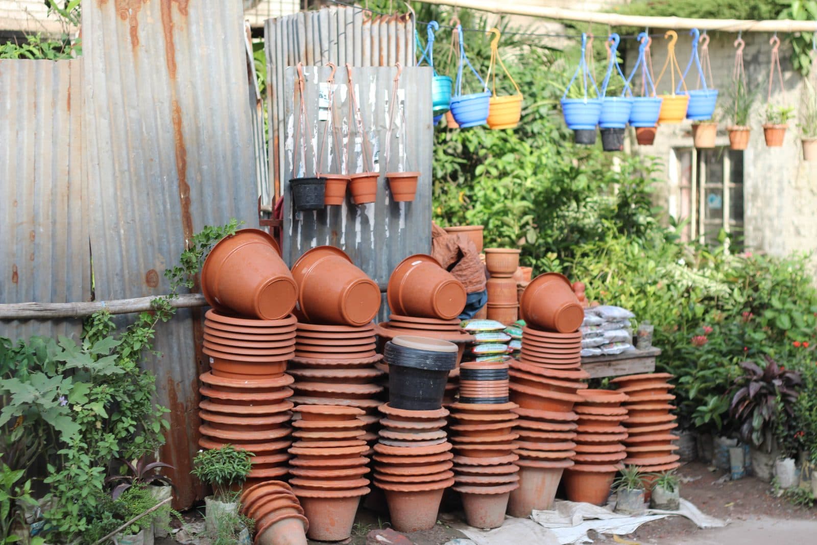 Terracotta and plastic garden pots side by side for a balcony garden